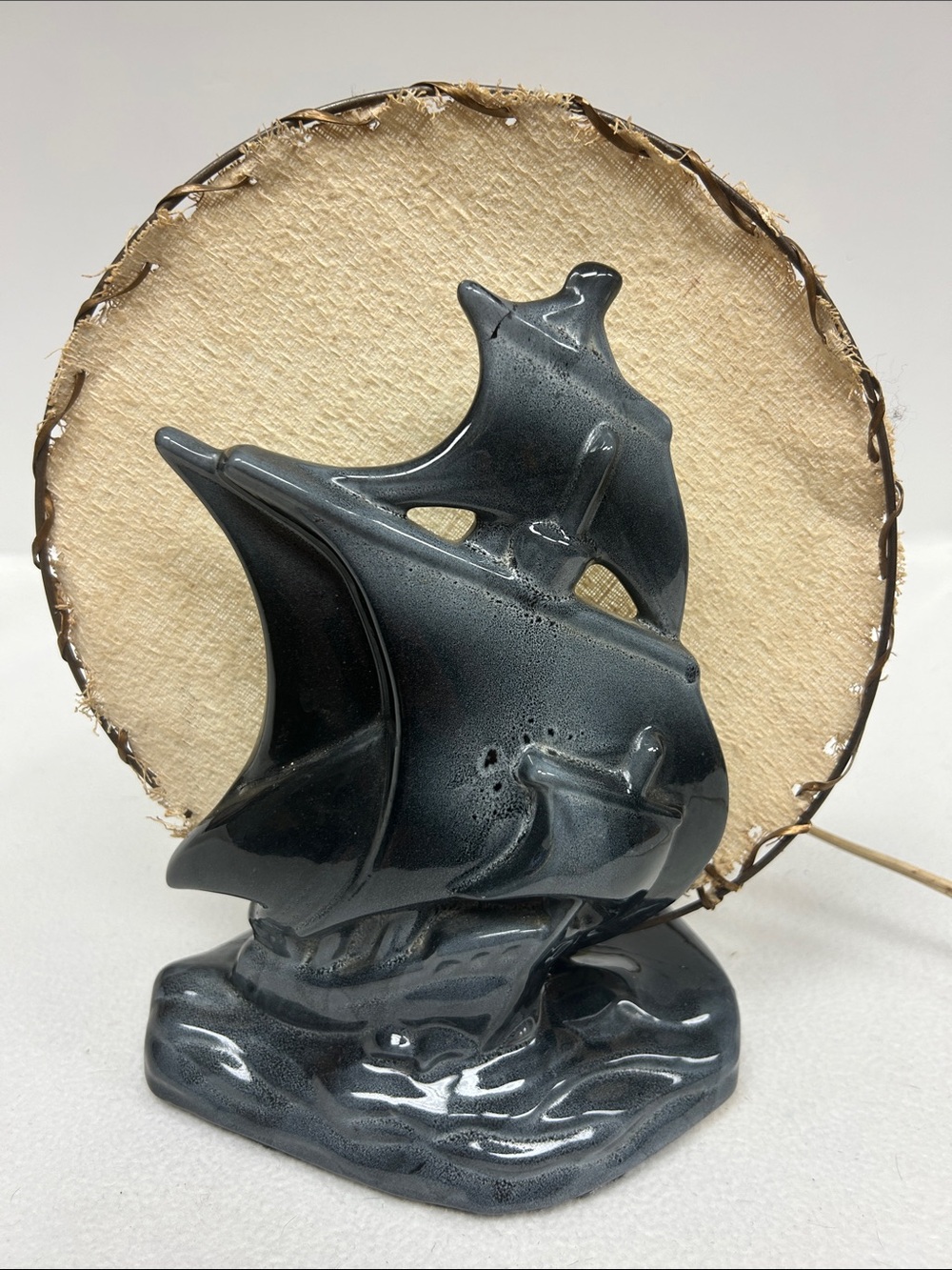 Vintage 1950’s black ceramic Tall Ship TV lamp with burlap on metal hoop shade